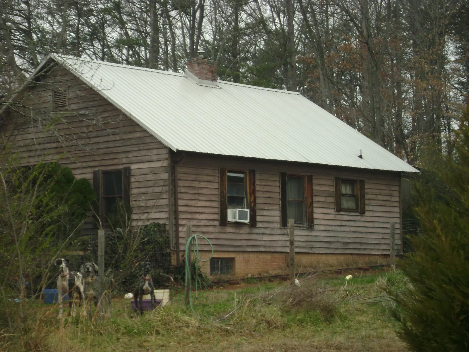 White metal roof on an old wood sided farmhouse, from a Metal Roof Installation job in West Decatur